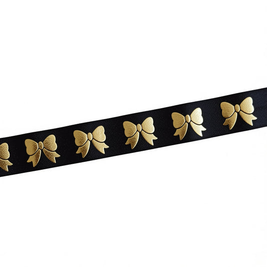 A black ribbon with gold embroidered bows on it.
