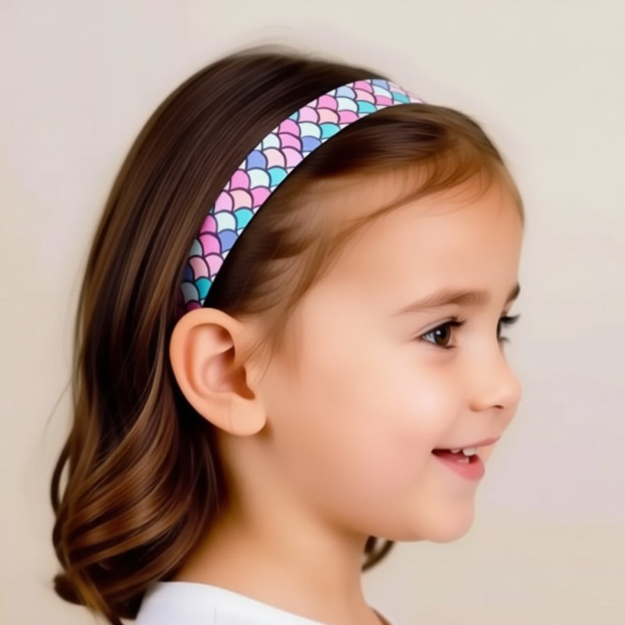 a colorful, patterned strap with a black object attached to it, possibly a hearing aid or similar device.