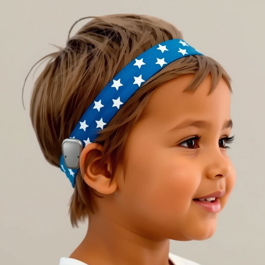 A young child shown in side profile wearing a blue ponto baha softband with white stars