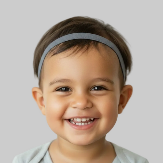 a young child with brown hair wearing a hearing aid headband or cochlear implant headband, 10mm wide silicone lined