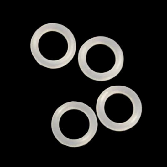 Four clear silicone o-rings on a black background