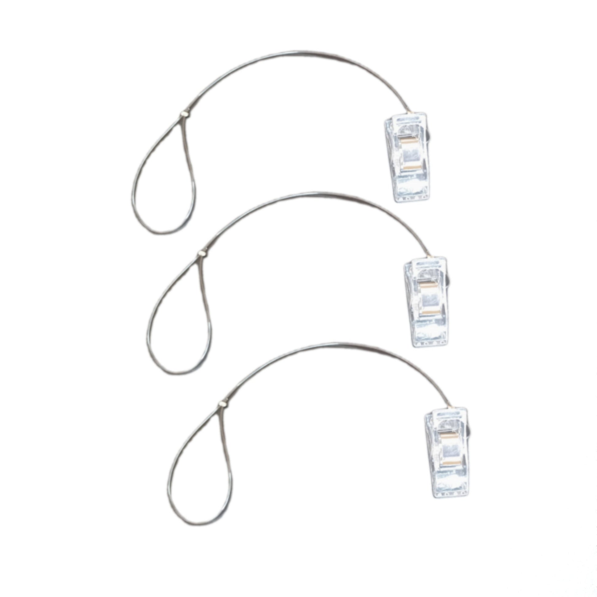 Set of three clear plastic BAHA clips on a thin black lanyard against a white background