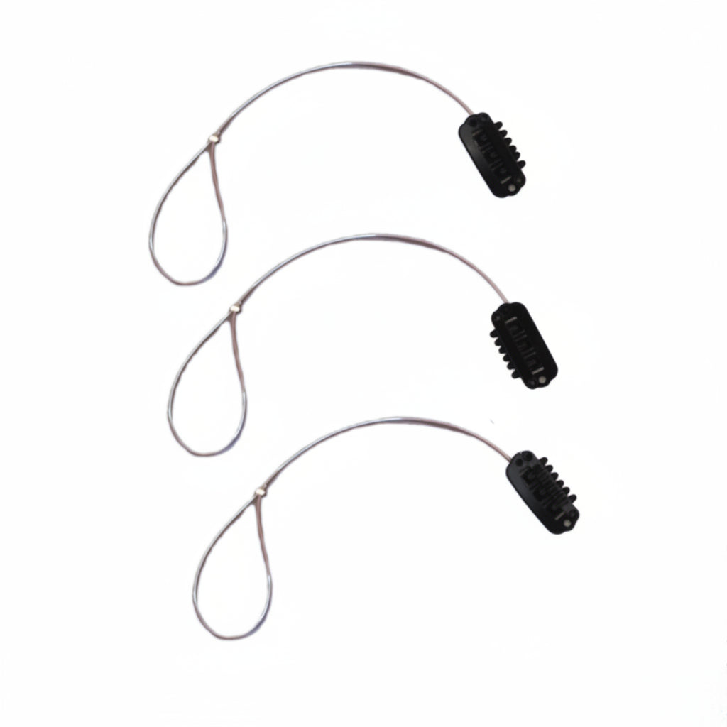 Three BAHA Ponto osia sentio adhear retaining lines with black wig clip on a white background