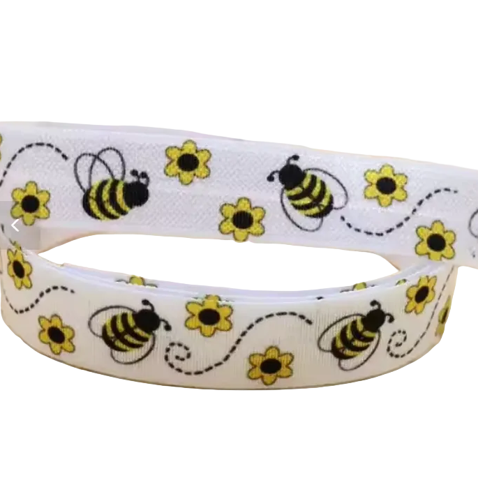 Ponto Baha softband hearing aid headband cochlear implant with a pattern of yellow flowers and black-and-yellow bumblebees