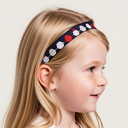A cochlear implant headband with a repeating pattern of small white and red penguins wearing Santa hats.
