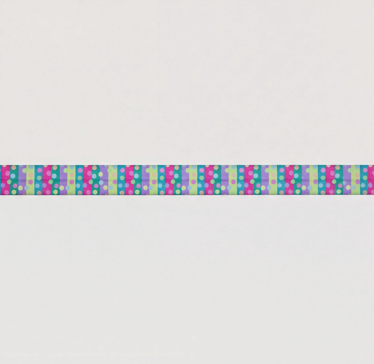 A long, colourful elastic for cochlear implant headband with a repeating pattern of pink, blue, and green polka dots.