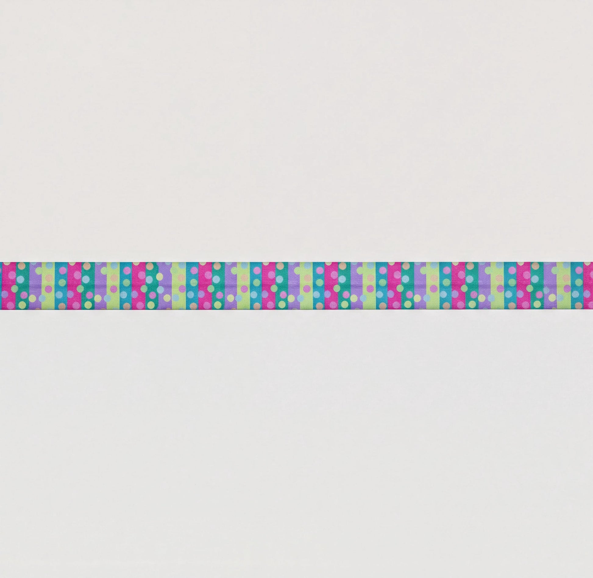 A long, colourful elastic for cochlear implant headband with a repeating pattern of pink, blue, and green polka dots.