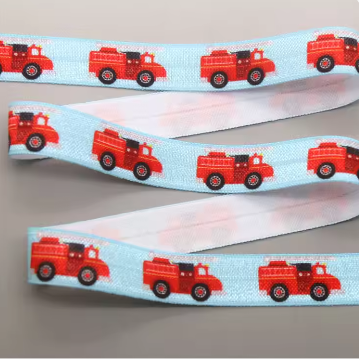 Ponto Baha softband hearing aid headband cochlear implant with a repeating pattern of red fire trucks.