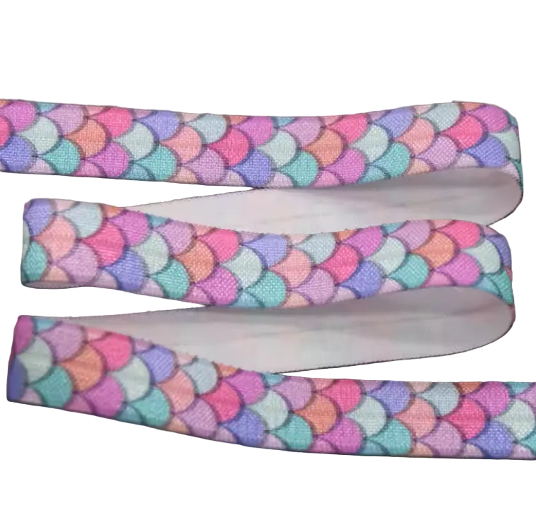 Ponto Baha softband hearing aid headband cochlear implant with a repeating mermaid scale pattern in pastel pink, purple, blue.