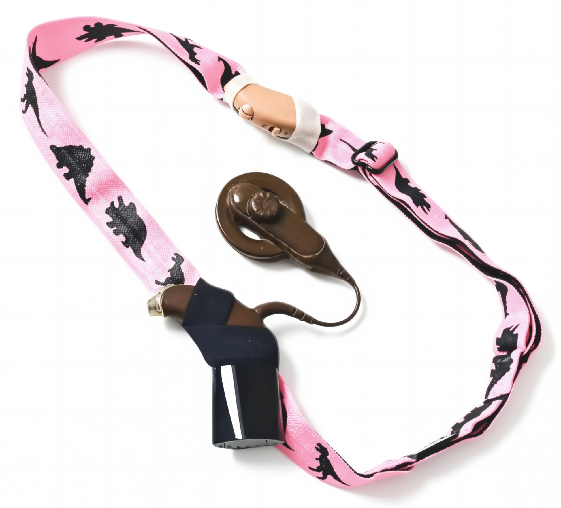 A pink adjustable headband with black dinosaur silhouettes, with a cochlear implant and hearing aid