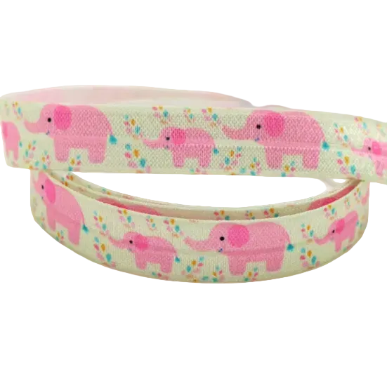 Ponto Baha softband hearing aid headband cochlear implant featuring a repeating pattern of pink cartoon elephants and small multicoloured flowers.