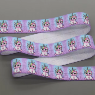 Ponto Baha softband hearing aid headband cochlear implant featuring a repeating pattern of cute pink and white cartoon unicorns.