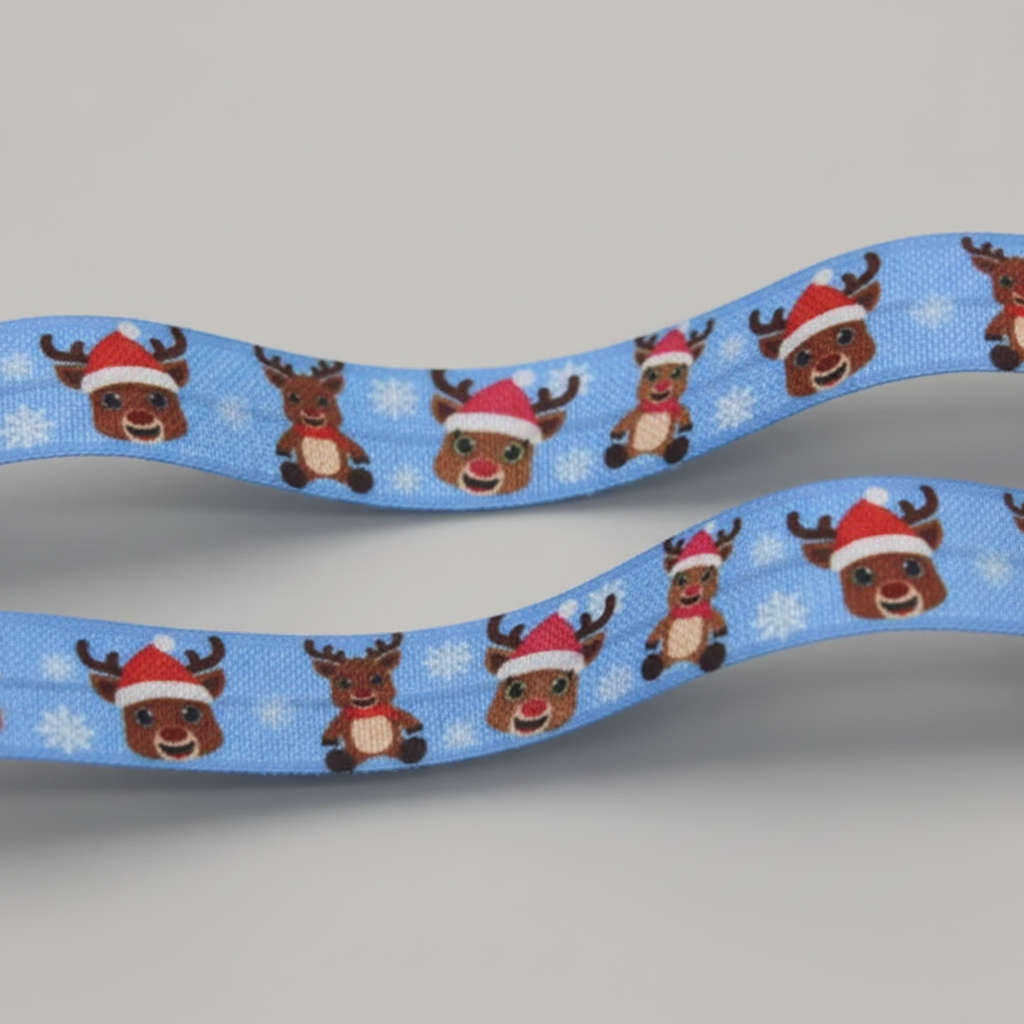 A light blue elastic hearing aid headband with a repeating pattern of cartoon reindeer wearing red Santa hats and white snowflakes