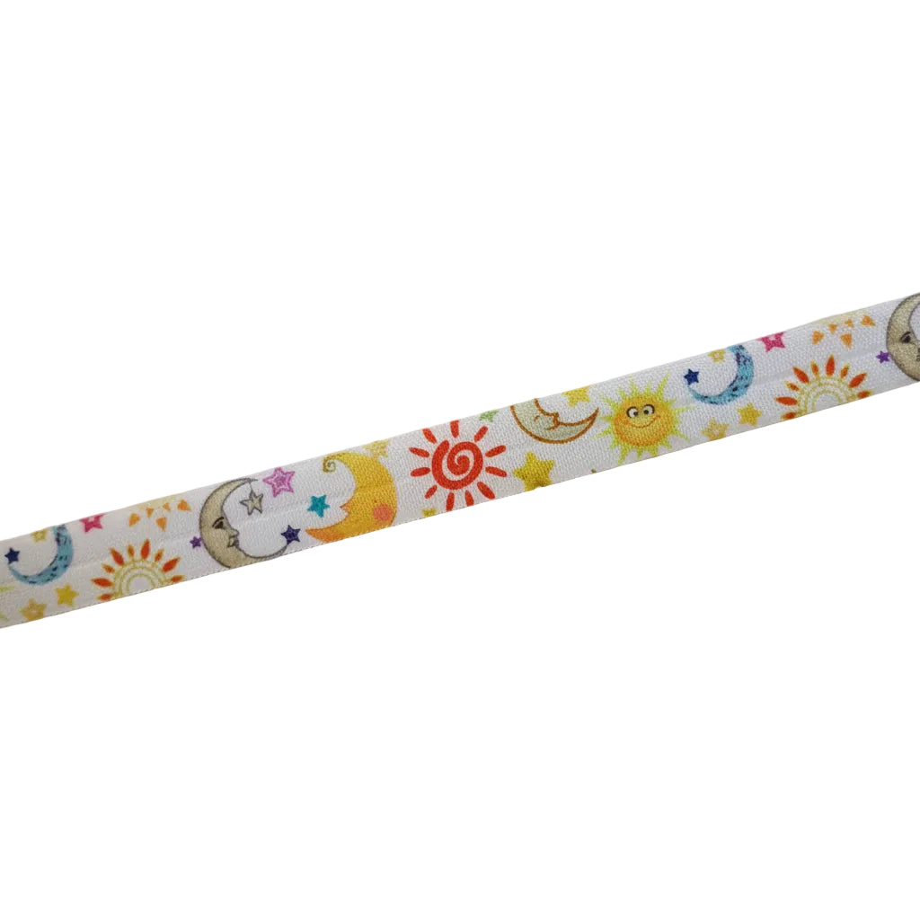 A close-up of a cochlear implant hearing aid headband featuring a colourful cartoon pattern of suns, crescent moons, and stars