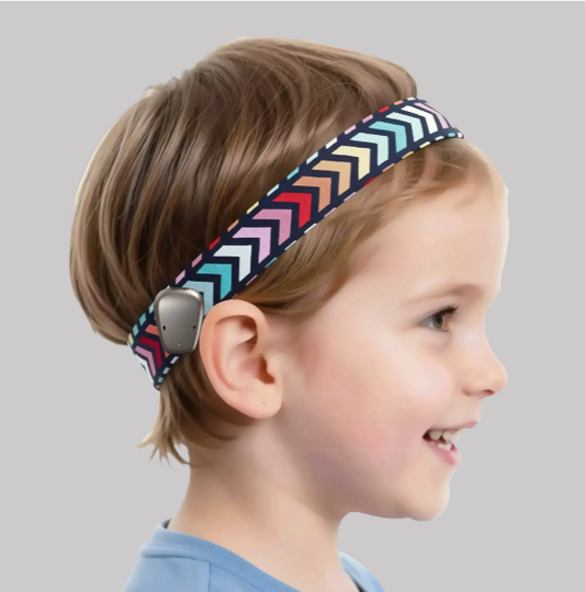 A child wearing a colorful chevron-patterned ponto baha softband with a gray electronic device attached near the ear, shown in profile against a light gray background.