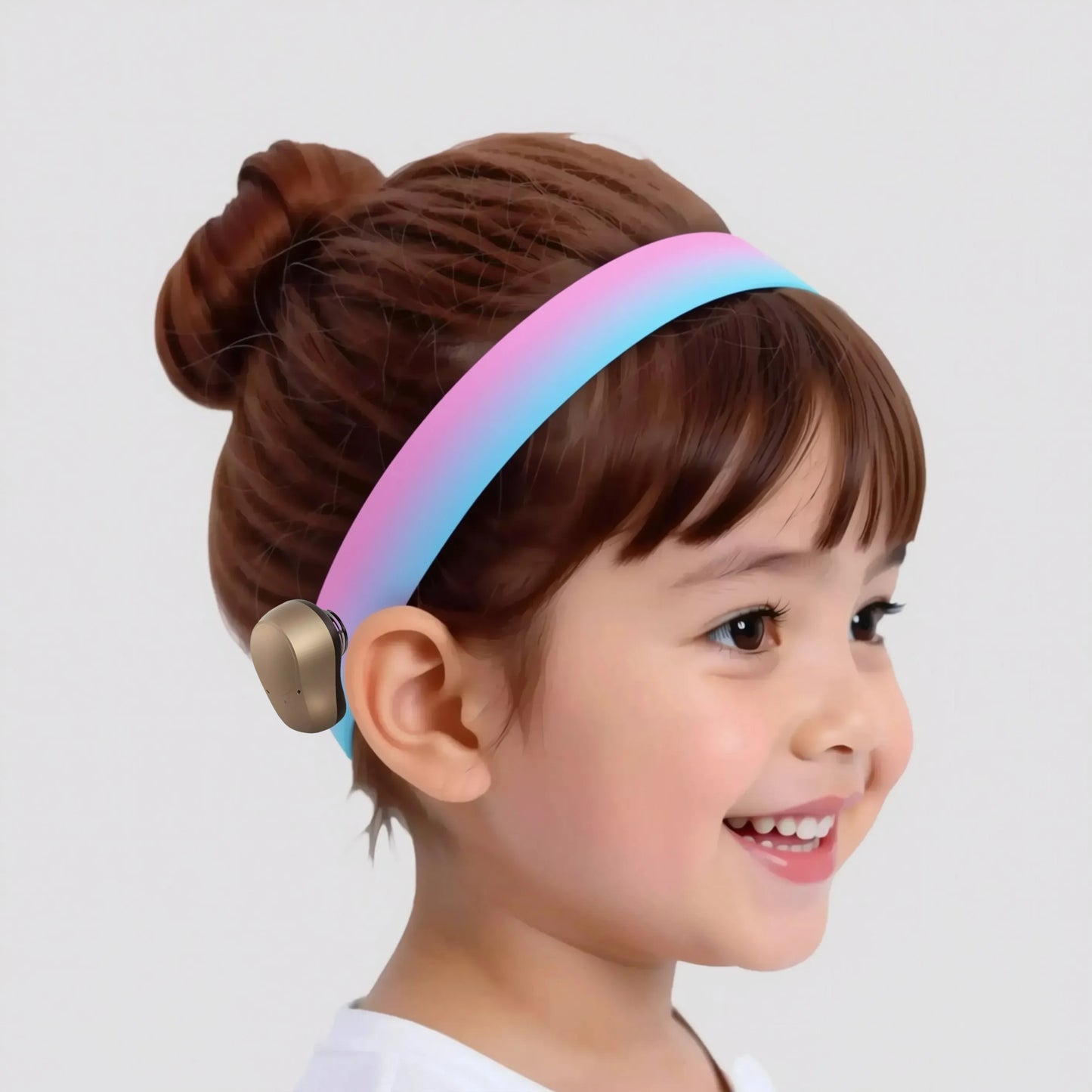 A young girl with brown hair wearing a pink and blue headband smiles at the camera.