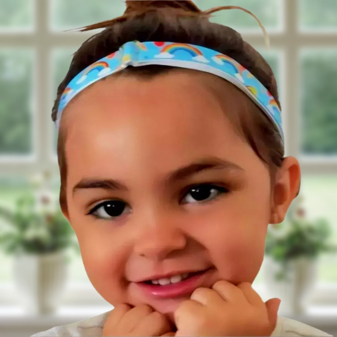 Child wearing a cochlear implant hearing aid headband with ponto baha bone-conduction hearing device attachments