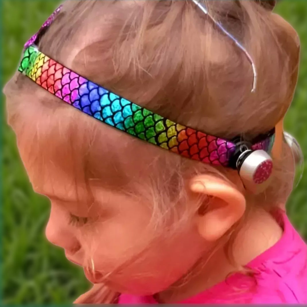 Child wearing a colourful softband with a ponto baha bone-conduction device
