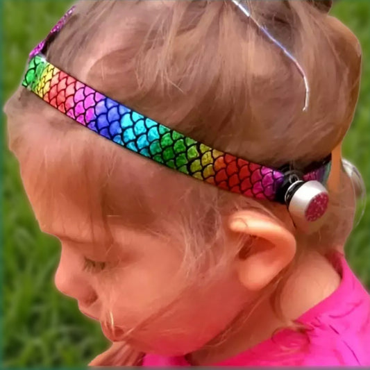 Child wearing a colourful softband with a ponto baha bone-conduction device