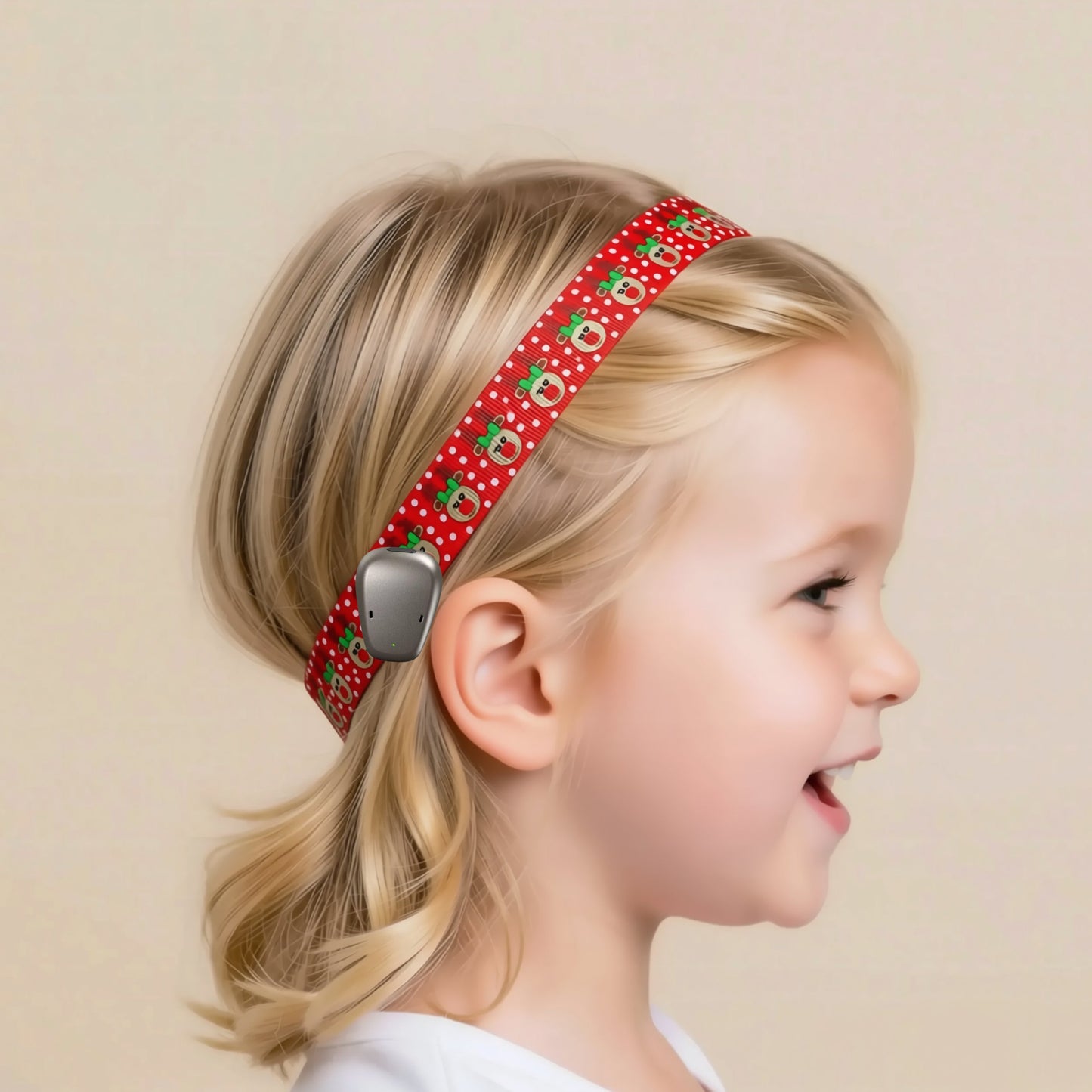 A young blonde girl in profile wearing a red holiday-themed ponto BAHA hearing aid headband with reindeer print