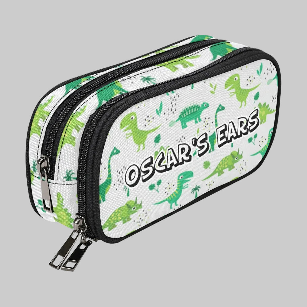 A white double-zipper storage case for cochlear implant hearing aid Ponto BAHA devices featuring a green dinosaur pattern and the text 'OSCAR'S EARS' in a stylized font, shown on a plain white background.