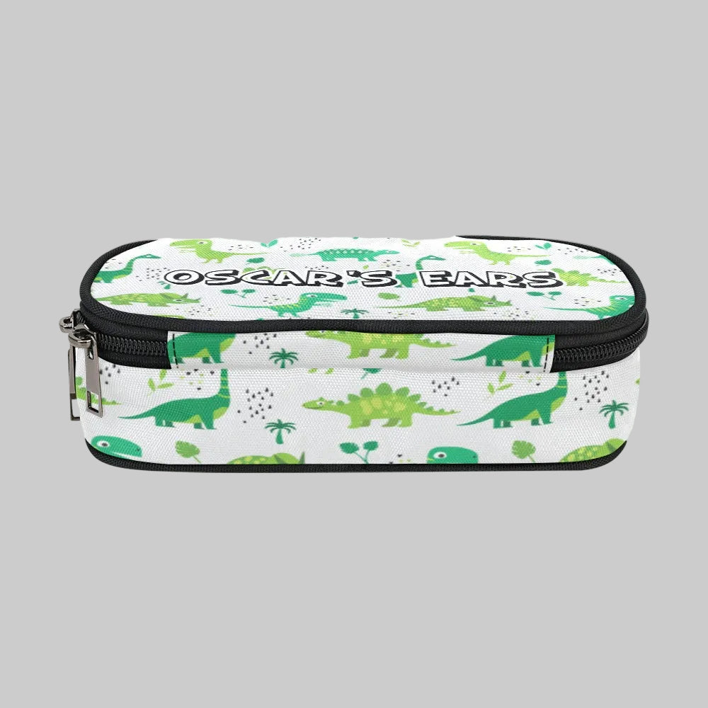 A rectangular zippered storage case for cochlear implant hearing aid Ponto BAHA devices with a white background and a green dinosaur pattern, featuring the text 'OSCAR'S BARS' across the top. 