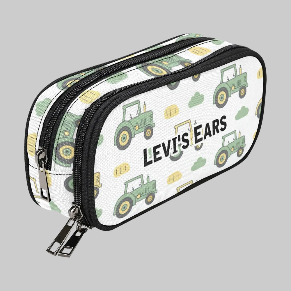 A white double-zipper storage case for cochlear implant hearing aid baha devices with a green tractor and yellow construction vehicle pattern, featuring the text 'LEVI'S EARS' in black. The case is shown on a plain white background.