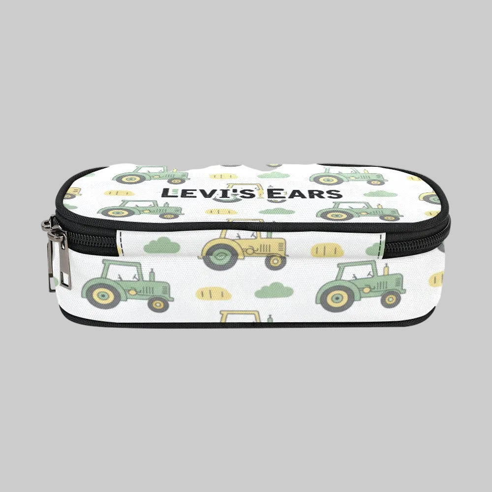 A rectangular zippered storage case for cochlear implant hearing aid Ponto BAHA devices with a white background and a repeating pattern of green and yellow tractors. The text 'LEVI'S EARS' is printed across the front in black.