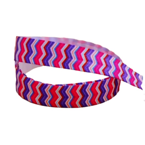 A colorful, zigzag-patterned ribbon is displayed on a wooden surface.