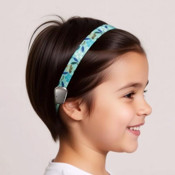 A turquoise ribbon with a floral pattern of white and blue flowers and leaves.